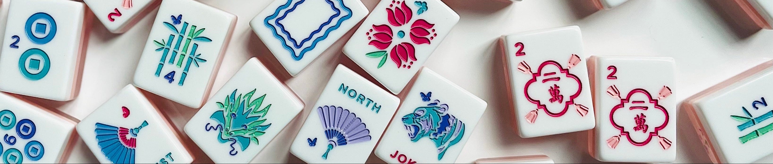 Collection of colorful mahjong tiles on a light surface