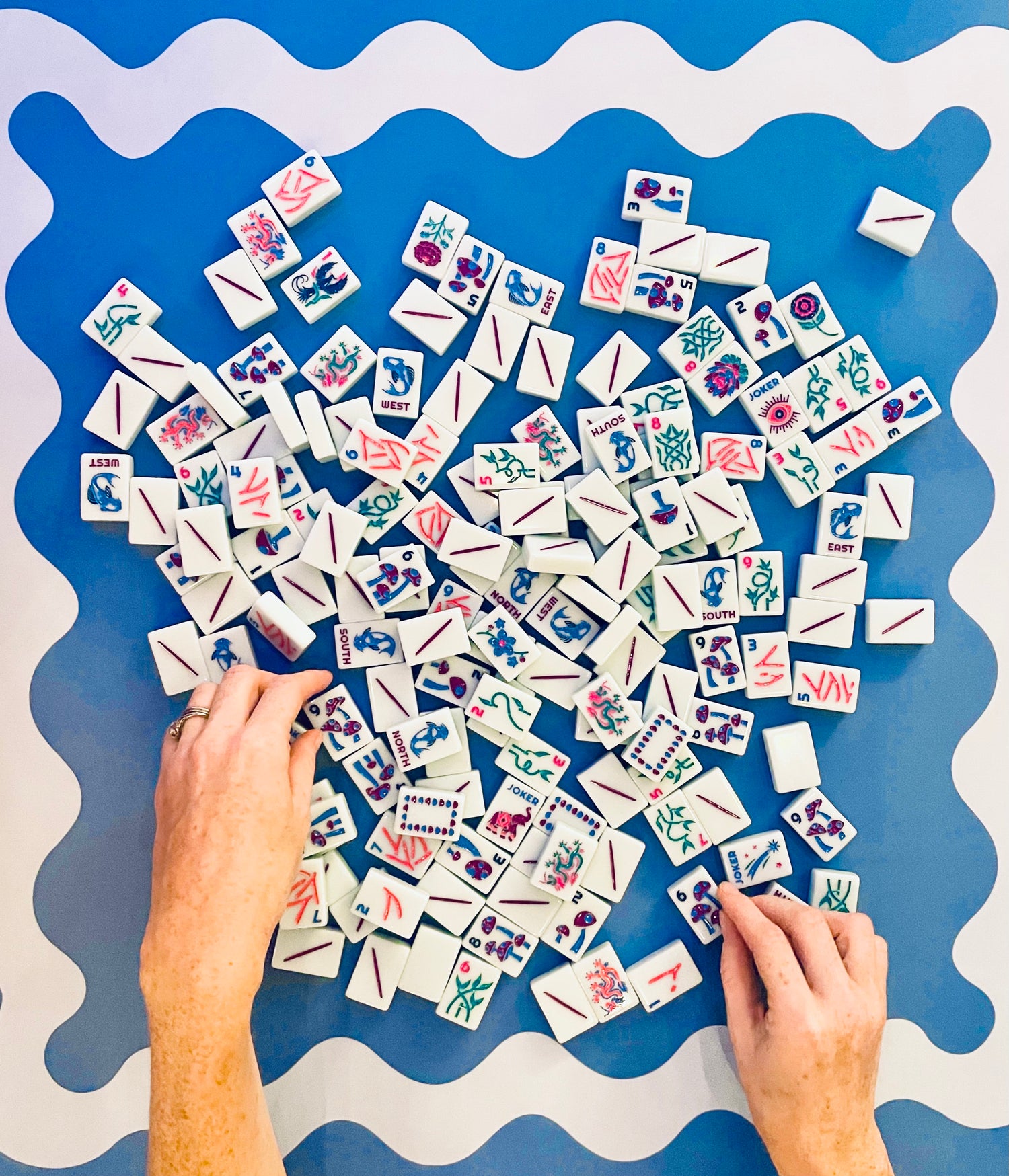 Colorful tiles with various designs on a blue and white surface